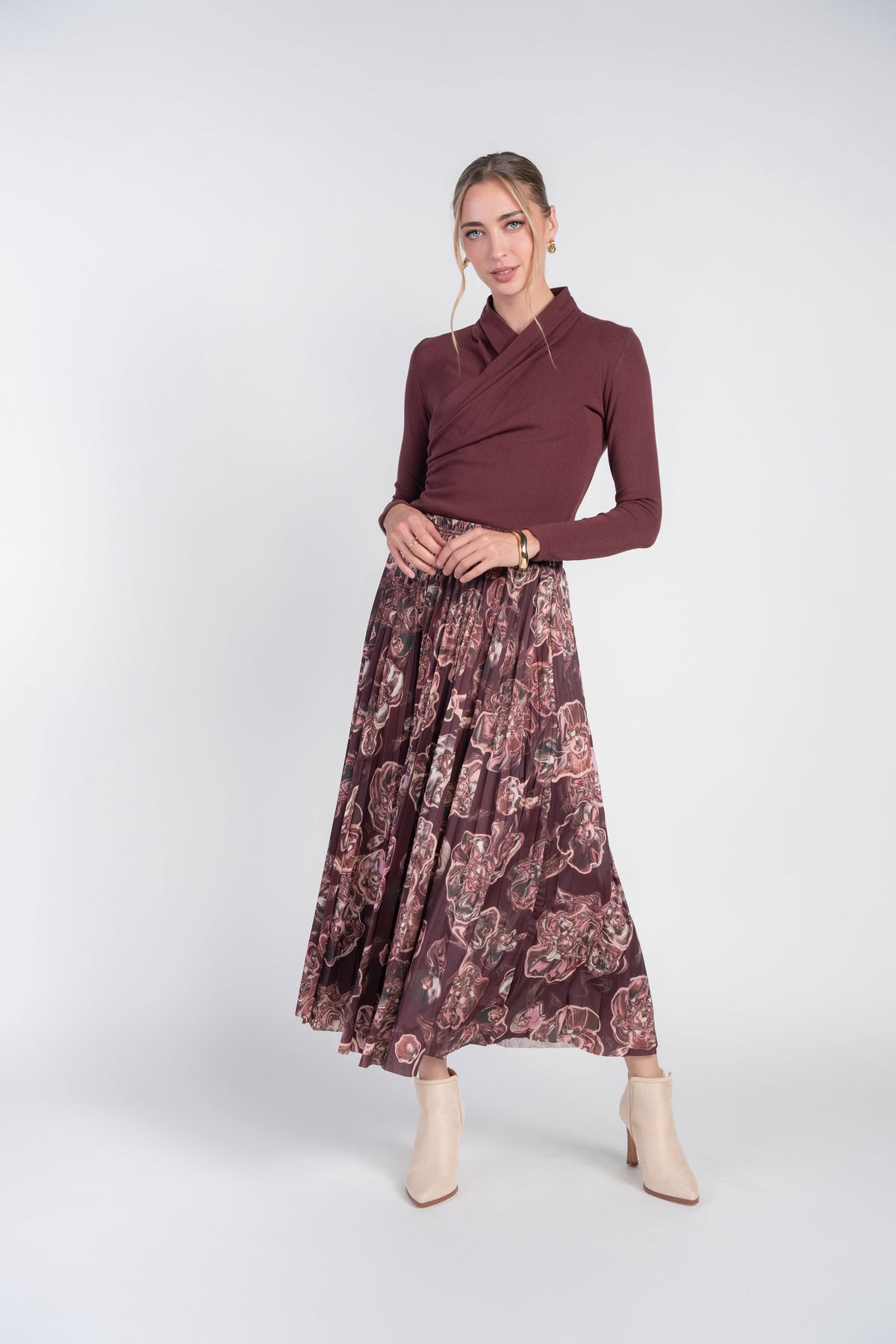 Burgundy swirls Jersey pleated skirt by Adina Las Vegas, featuring flowing pleats and a stylish swirl pattern.