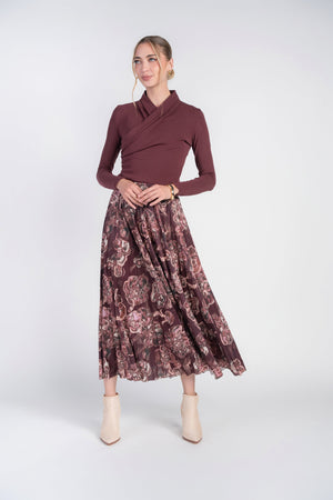 Burgundy swirls Jersey pleated skirt by Adina Las Vegas, featuring flowing pleats and a stylish swirl pattern.