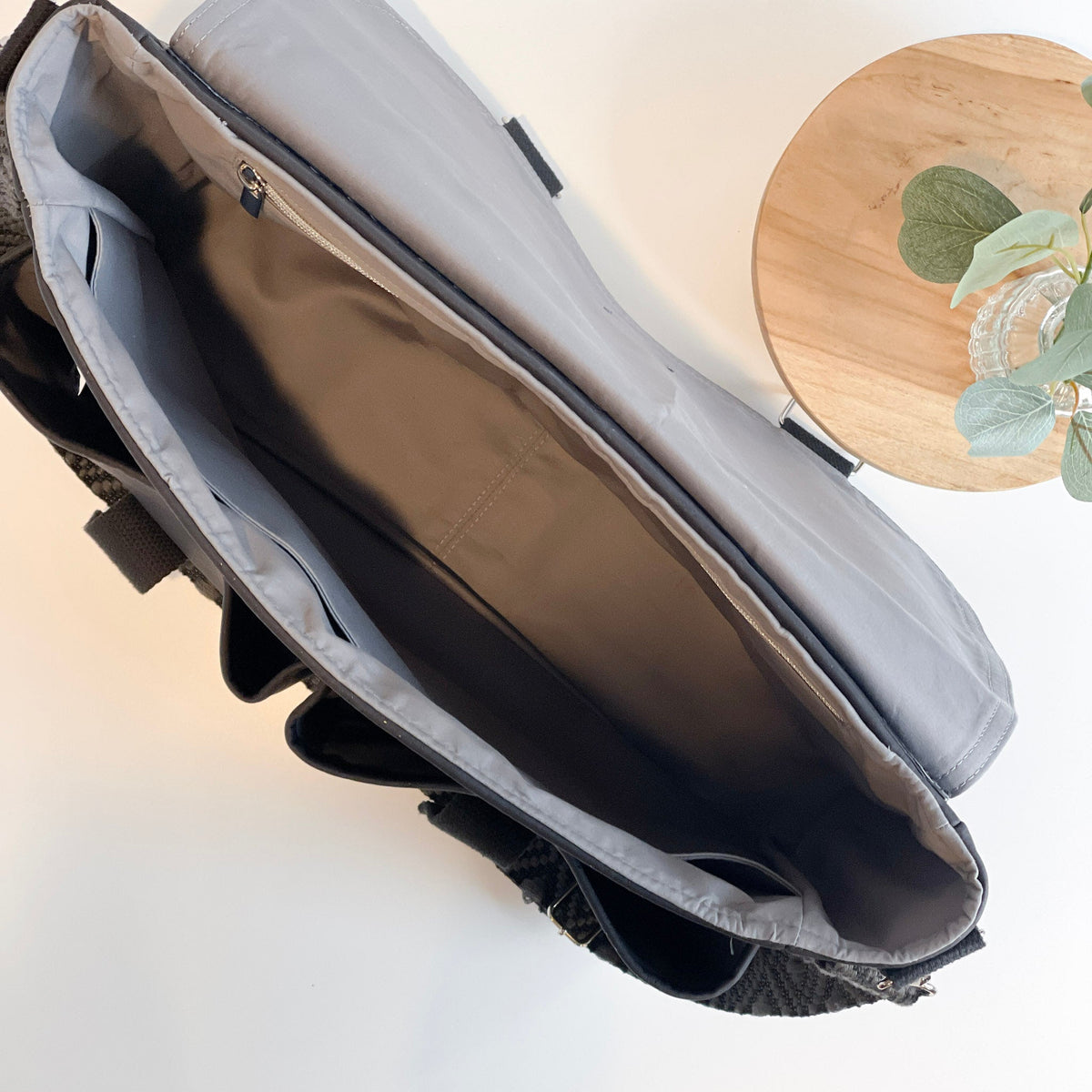 Carry Courage NOMAD messenger bag in coal black, showing its structured design and adjustable shoulder strap