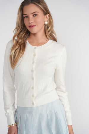 White floral open stitch cardigan top by Adina Las Vegas featuring a lightweight, airy knit with floral patterns.