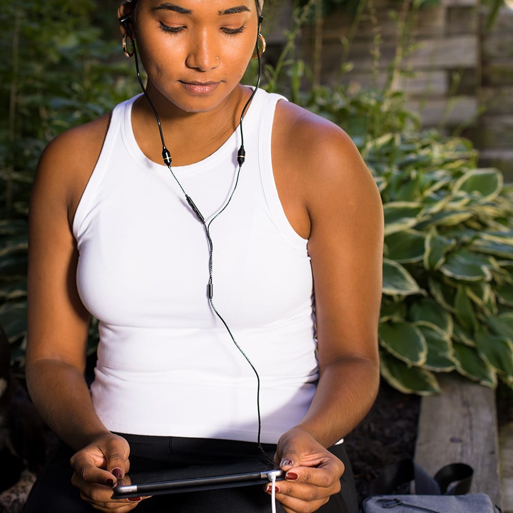 Shield Your Body SYB Tablet Pad shown with a woman sitting outdoors holding a tablet stand