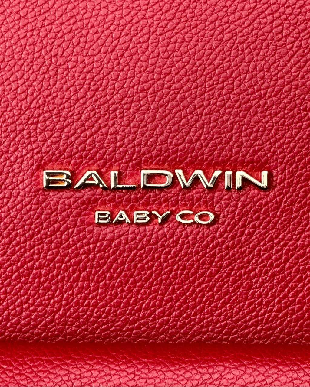 Baldwin Baby Company Daphne diaper bag in crimson with close-up logo detail