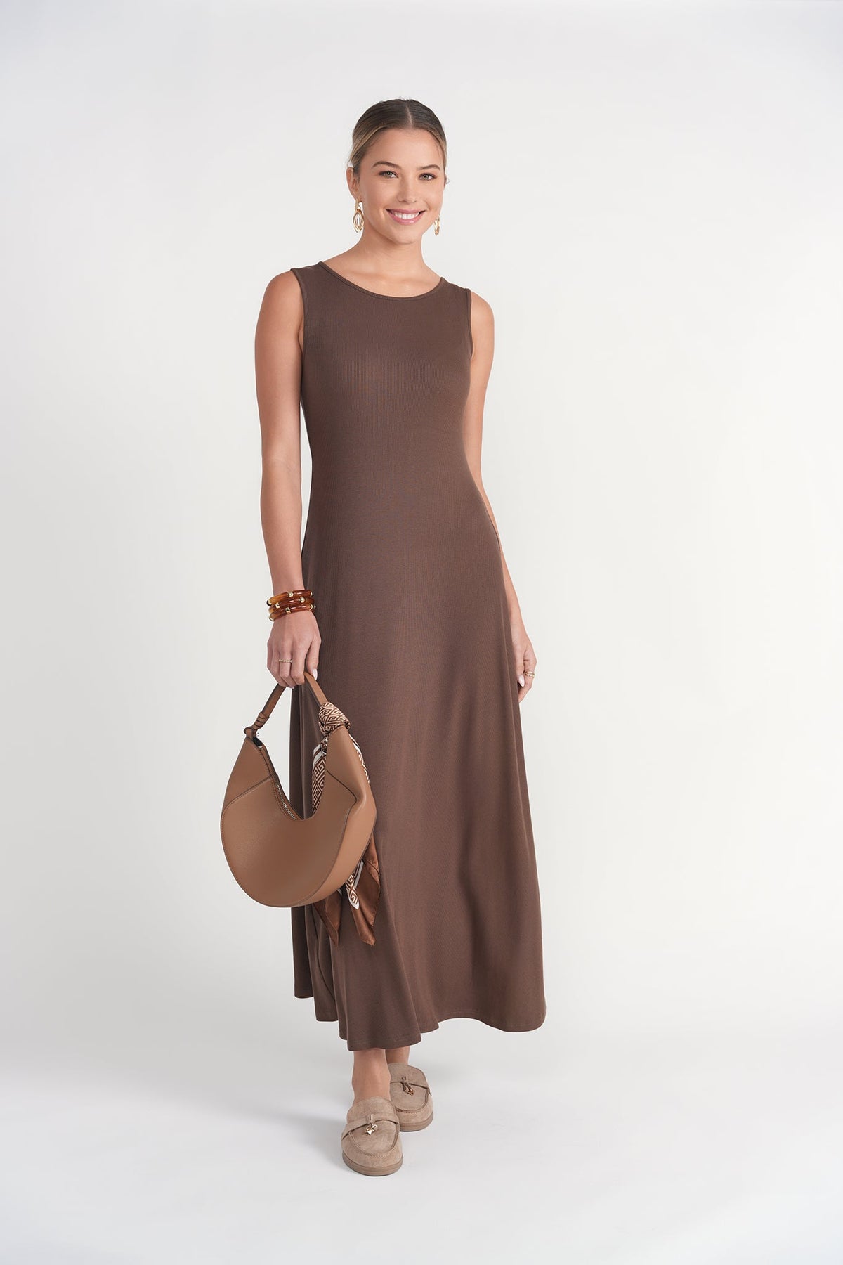 Chocolate sleeveless ribbed dress by Adina Las Vegas, showcasing a fitted design with a high neckline and textured fabric.