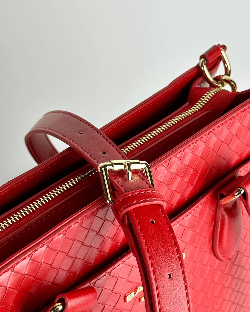 Baldwin Baby Company Montrose diaper bag tote in cardinal with close-up view of shoulder strap