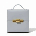 Leather Nina Cigar Box Bag by thebagicon featuring a structured rectangular shape with a top handle and classic design.