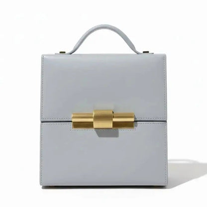 Leather Nina Cigar Box Bag by thebagicon featuring a structured rectangular shape with a top handle and classic design.