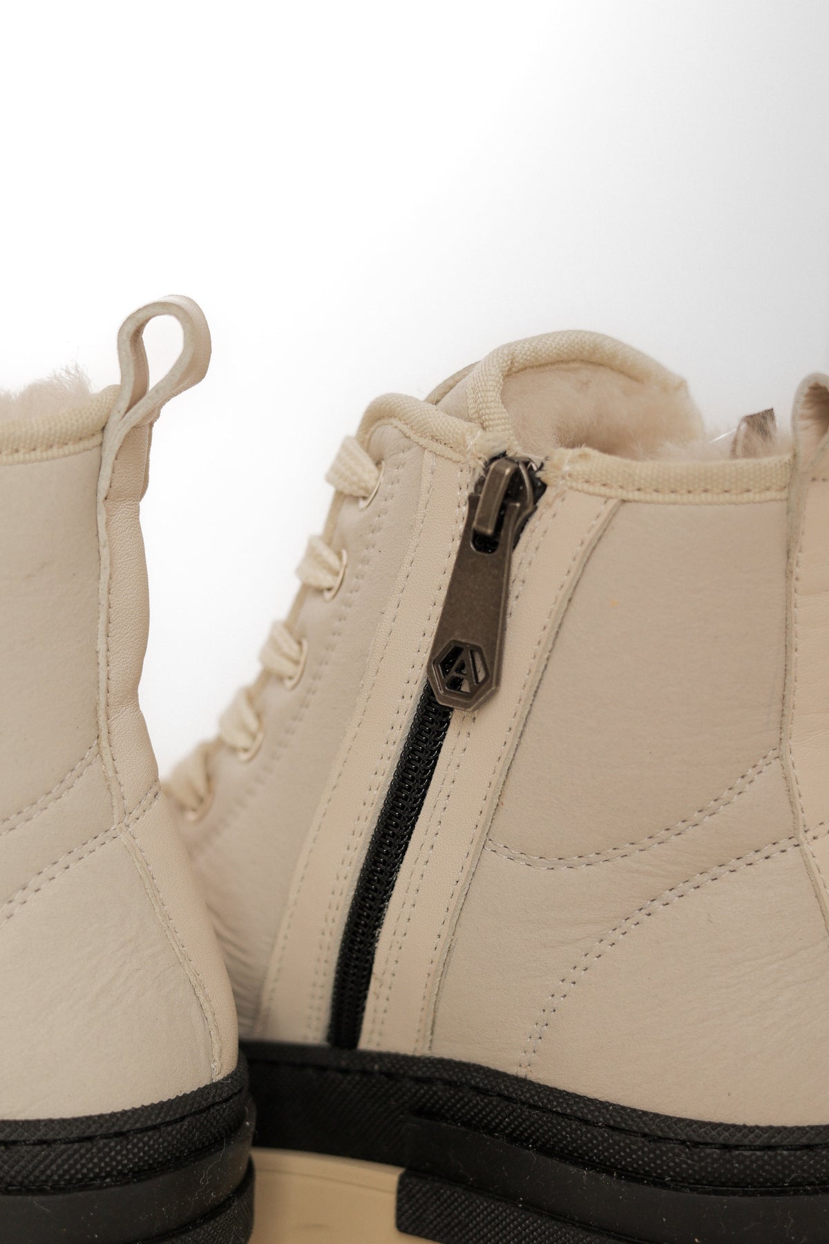 Alaska® Outerwear Company Aspen genuine shearling lined winter boots with rugged design and warm interior for cold weather.