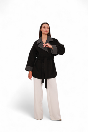 Black Sandro cashmere blend overcoat by Alaska® Outerwear Company, shown hanging with a tailored fit and smooth fabric.