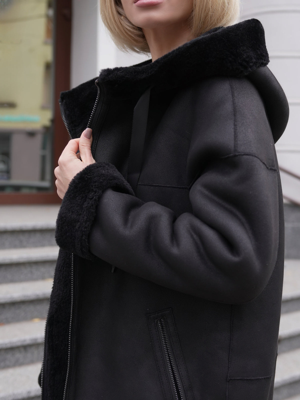 Alaska Outerwear Company Grazia reversible black faux shearling hooded coat parka pose.