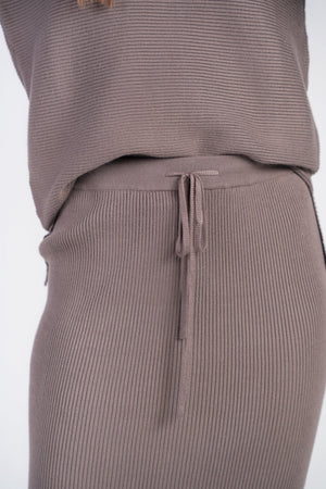 Ribbed mushroom-colored sweater skirt by Adina Las Vegas, showing the textured knit fabric and high-waisted design.