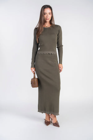 Olive scalloped knit skirt by Adina Las Vegas displayed on a model, showing the textured hem and fitted waist detail.