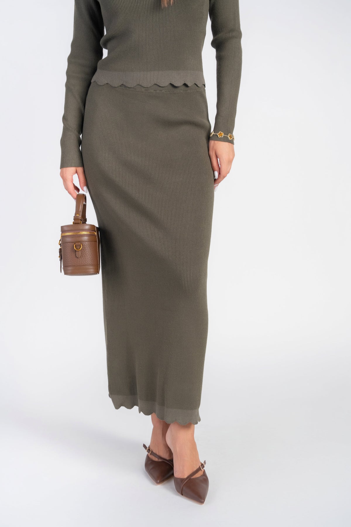Olive scalloped knit skirt by Adina Las Vegas, showcasing a stylish, textured design with a flattering A-line silhouette.