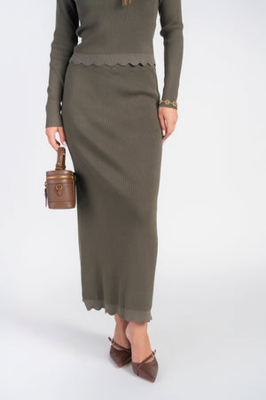 Olive scalloped knit skirt by Adina Las Vegas, showcasing a stylish, textured design with a flattering A-line silhouette.