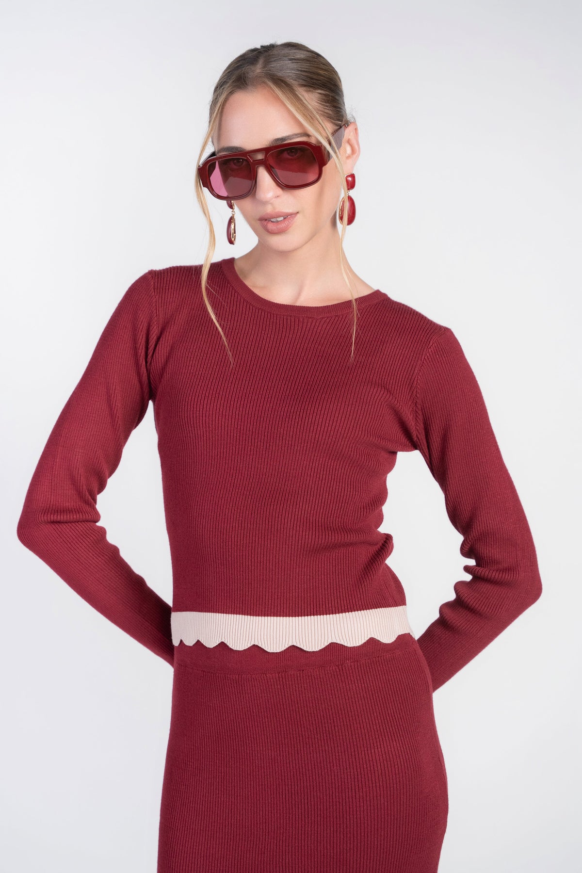 Bordeaux scalloped knit top by Adina Las Vegas, close-up of the textured fabric and intricate scalloped hem design.
