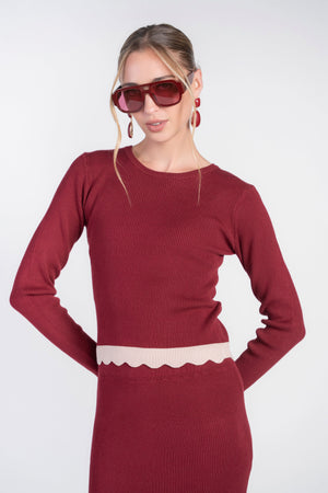Bordeaux scalloped knit top by Adina Las Vegas, close-up of the textured fabric and intricate scalloped hem design.