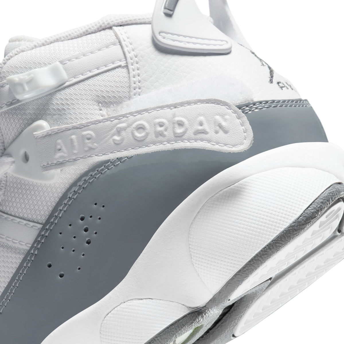 White and cool grey Air Jordan 6 Rings grade school sneakers with Nike branding and stylish design.