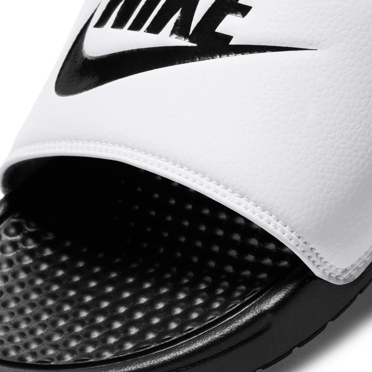 White Nike men's Benassi JDI slides with cushioned strap and textured sole\Seeder