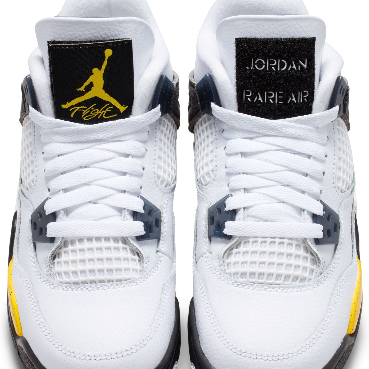 Bright yellow Air Jordan 4 Retro grade school sneakers with black accents, displayed on a plain background.
