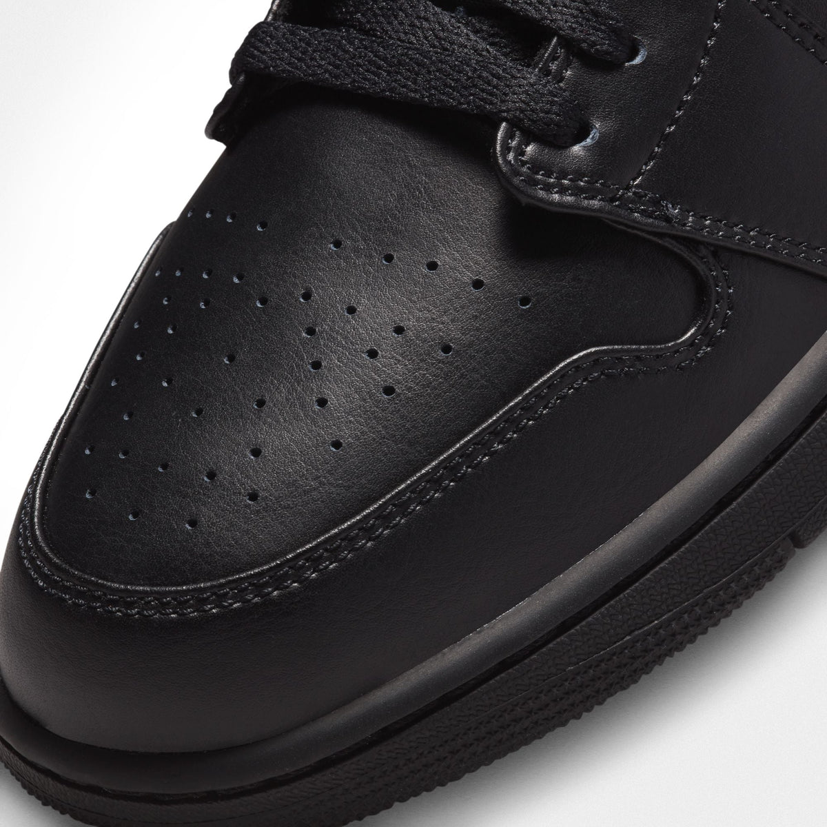 Denim Exchange Air Jordan Men's 1 Low sneakers in triple black, side view