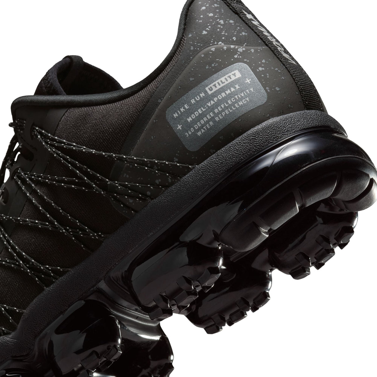 Nike men's Air Vapormax Run Utility sneakers in black with reflective silver accents, showcasing a sleek athletic design.