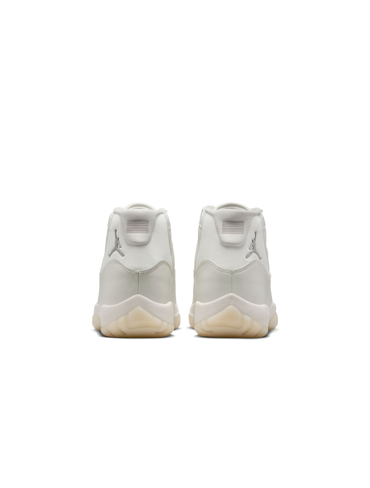 Women’s Air Jordan 11 Retro Pearl sneakers in white and silver, featuring a sleek design and shiny patent leather for stylish footwear.