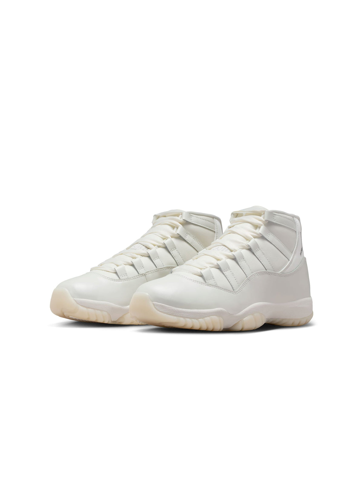 Womens Air Jordan 11 Retro Pearl sneakers in white and silver with patent leather accents, stylishly displayed on a plain background.