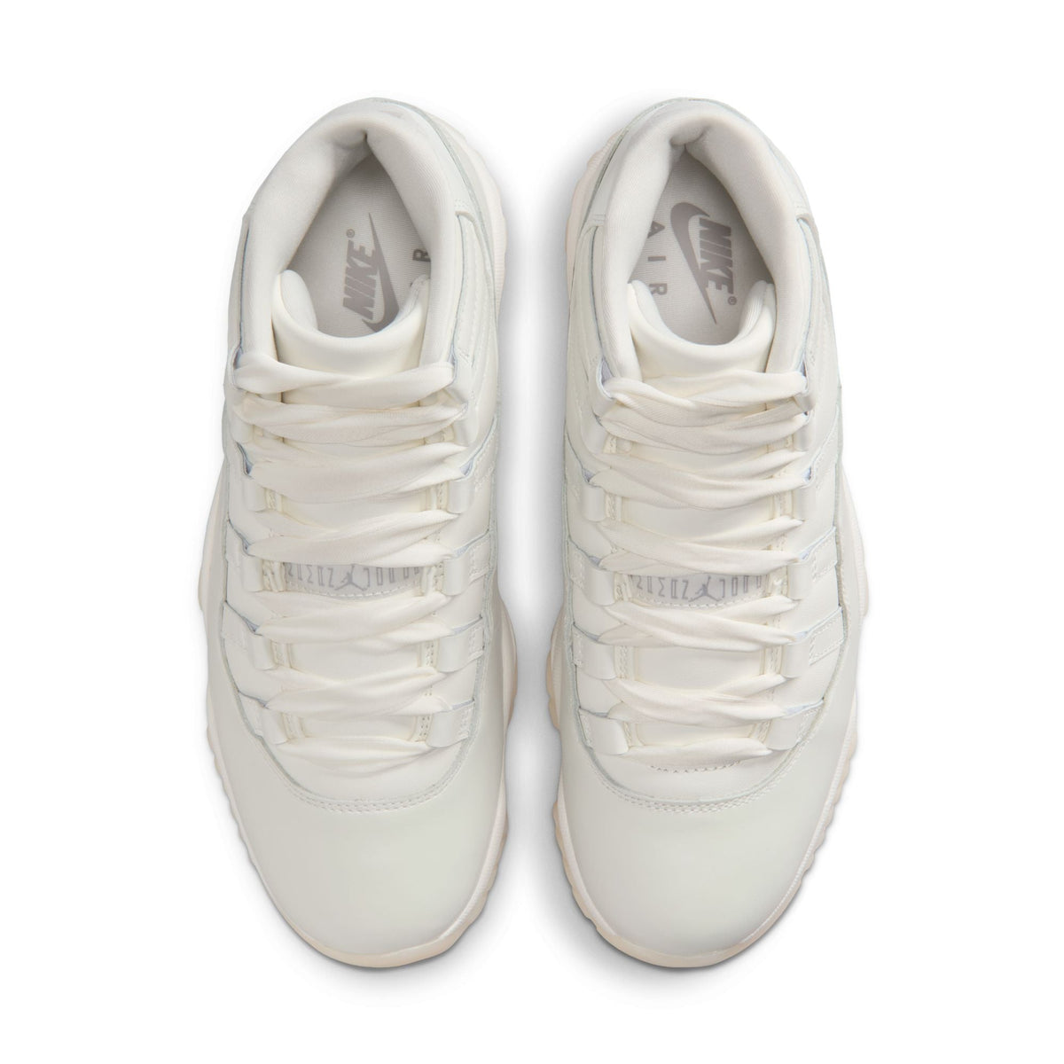 Women’s Air Jordan 11 Retro Pearl sneakers in white and pearl tones, featuring sleek design and high-top style.