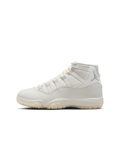 Women's Air Jordan 11 Retro Pearl sneakers featuring a sleek design and pearl accents, styled with white leather and patent finish.