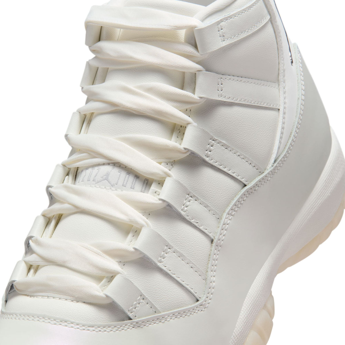 Women's Air Jordan 11 Retro Pearl sneakers featuring a sleek design and pearl accents, displayed on a clean background.