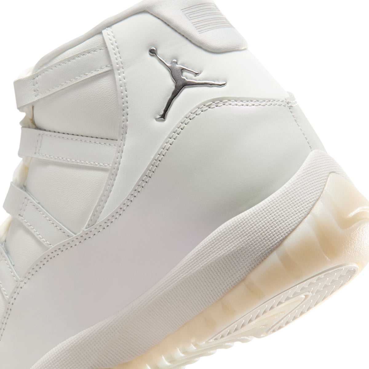 Women's Air Jordan 11 Retro Pearl sneakers in white and silver, featuring a sleek design and glossy patent leather finish.
