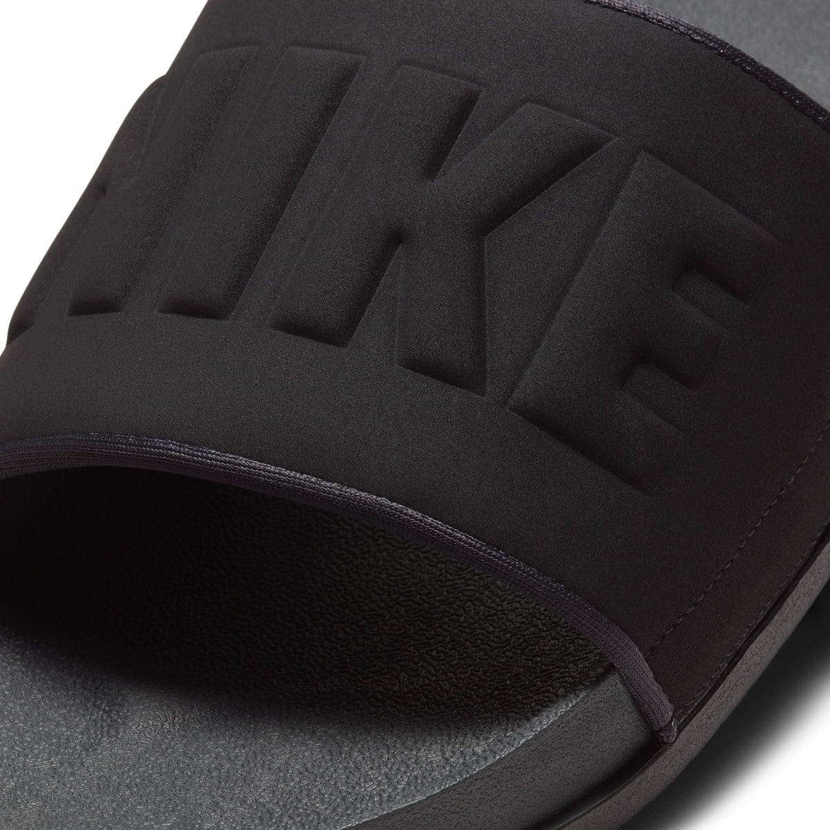 Nike men’s Offcourt slide in anthracite, side view showing cushioned strap and textured sole