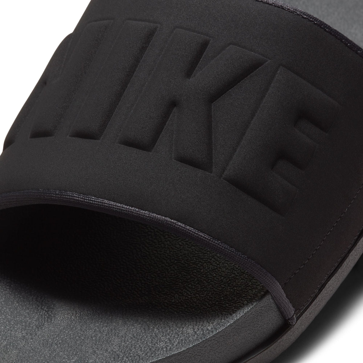 Nike men’s Offcourt slide in anthracite, side view showing cushioned strap and textured sole