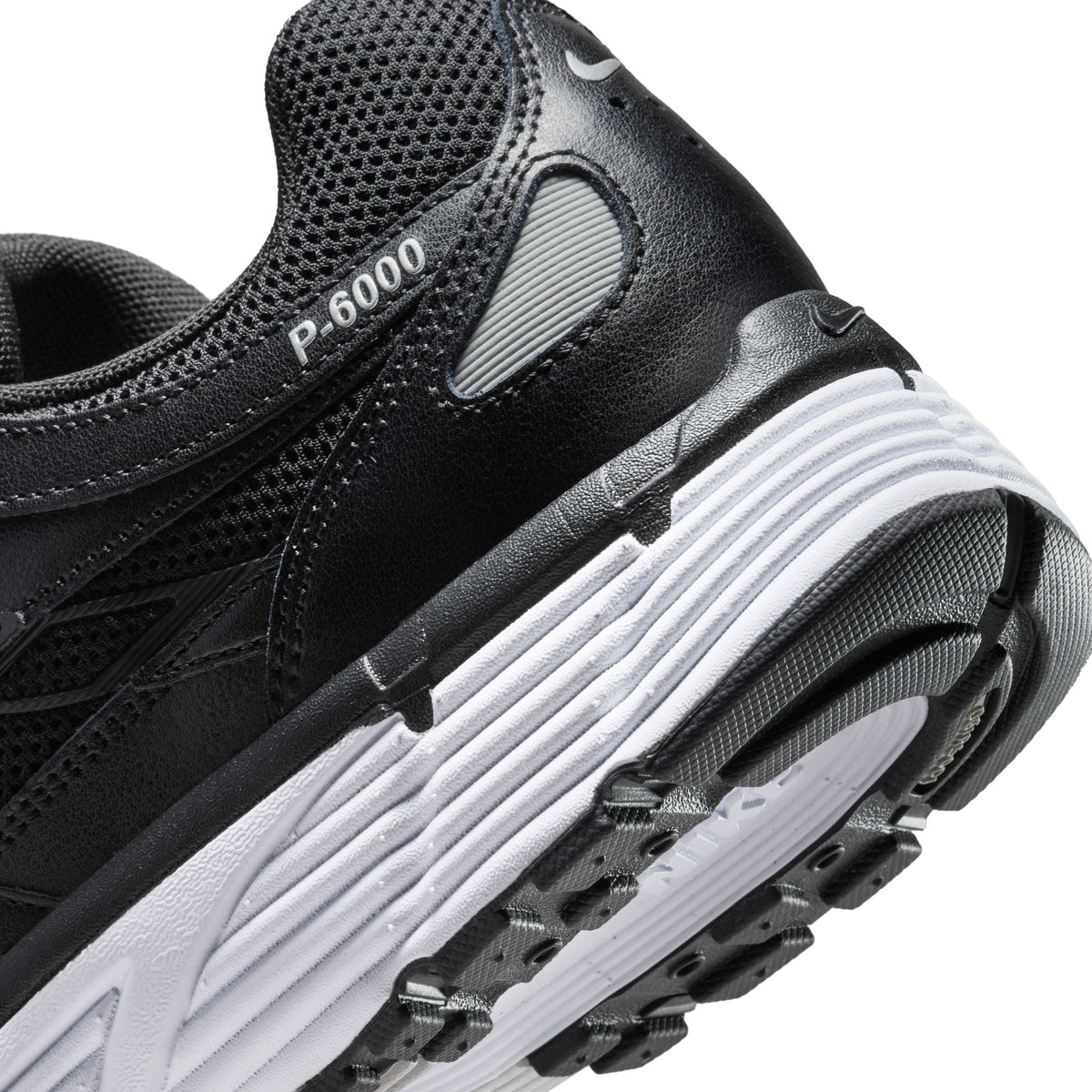 Nike men's P-6000 black sneakers by Denim Exchange, side view.