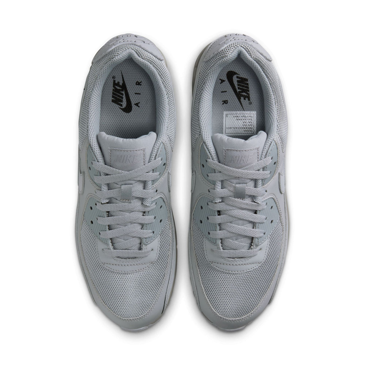 Nike men’s Air Max 90 sneakers in Wolf Grey, side view; Denim Exchange footwear product image