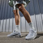 Nike men's Air Max 90 sneakers in Wolf Grey and black, side view.