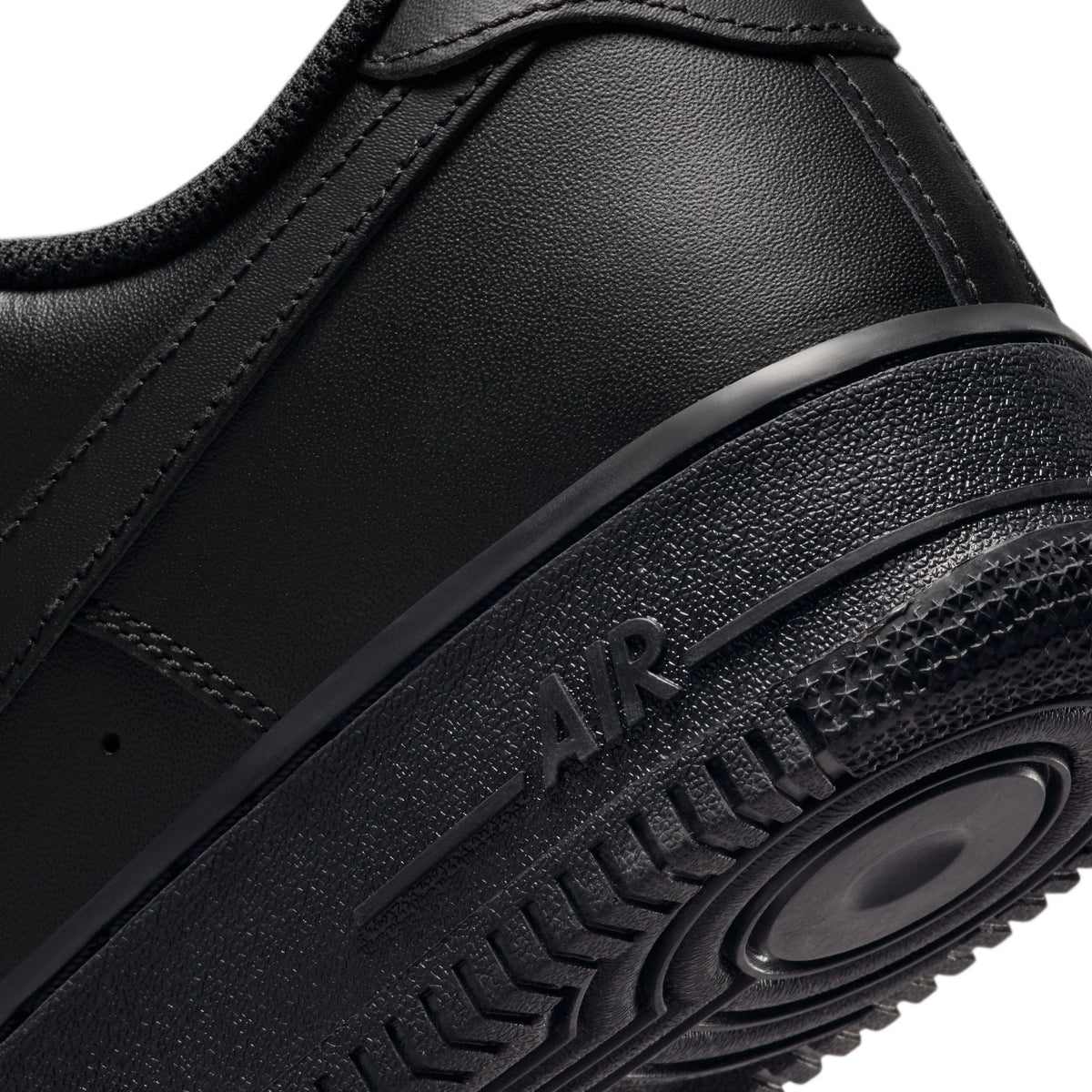 Nike Men's Air Force 1 '07 Triple Black sneakers, side view showing black leather upper and chunky sole