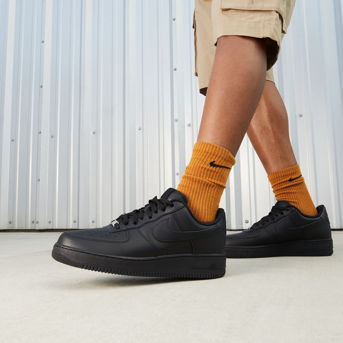 Denim Exchange Nike Men's Air Force 1 '07 Triple Black sneakers, side view with classic low-top design