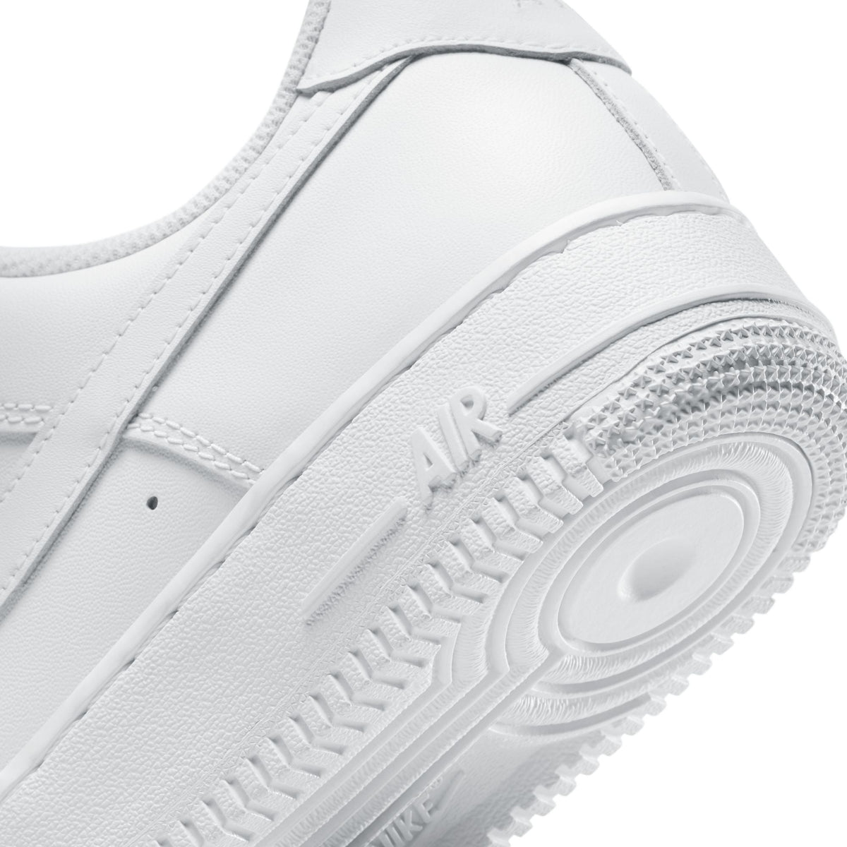White Nike Women's Air Force 1 '07 sneakers shown from a side angle, highlighting the clean leather design and classic silhouette.