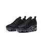 Black and anthracite Nike Women's Air Vapormax Plus sneakers with sleek design and cushioned sole.