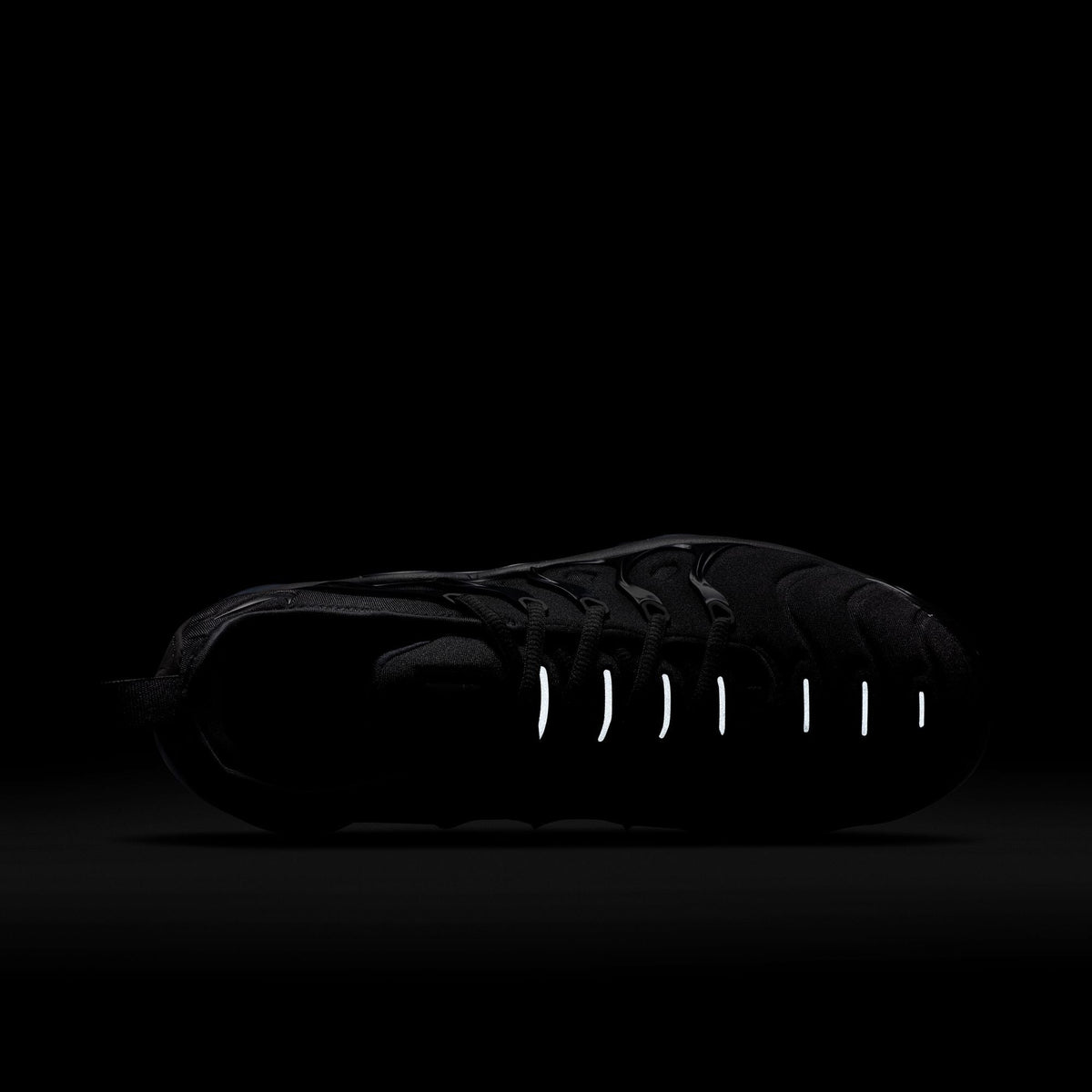Nike Women's Air Vapormax Plus black and anthracite running shoes with breathable mesh and responsive Air sole, showcased in profile.