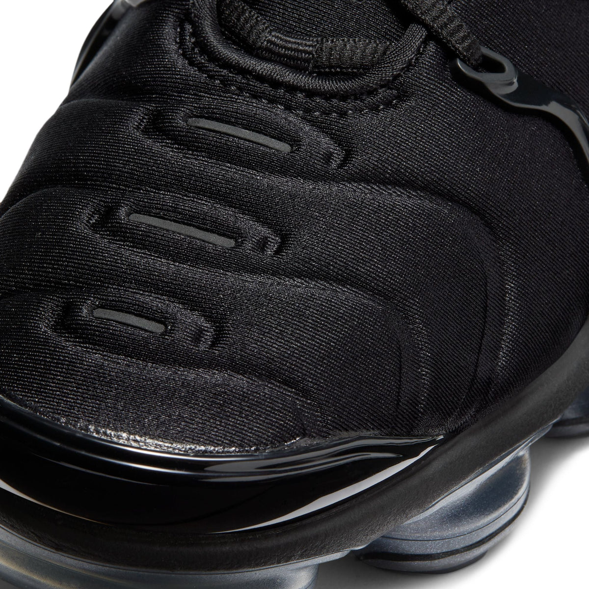 Nike Womens Air Vapormax Plus black-anthracite athletic footwear with visible Air cushioning and sleek design.