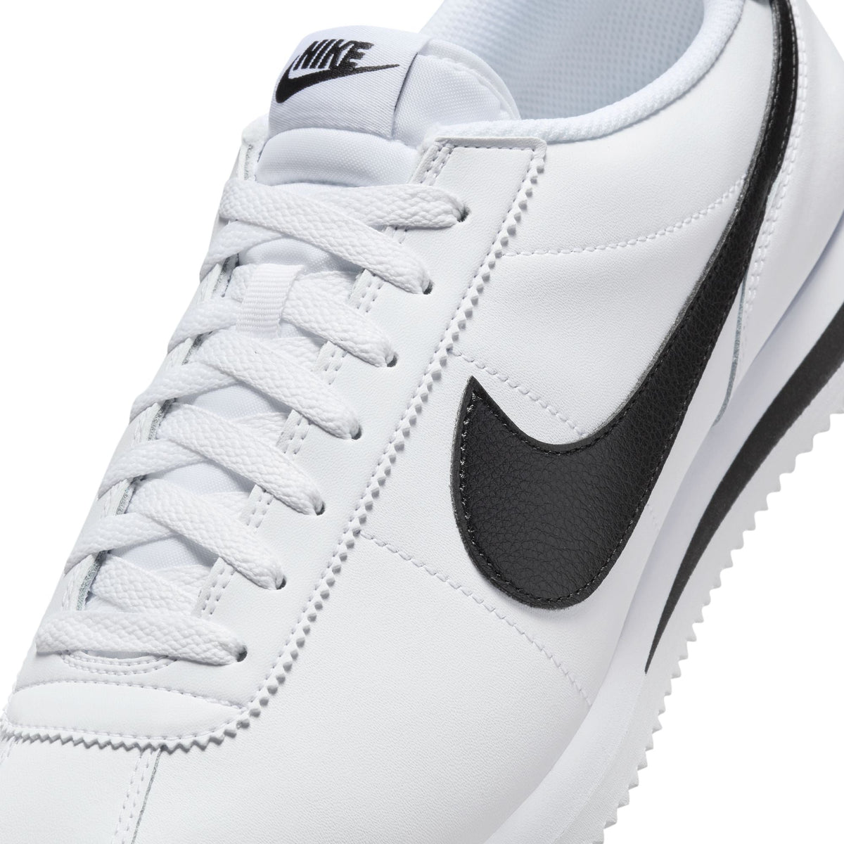 Nike men's Cortez white and black sneakers, side view with classic low-top design