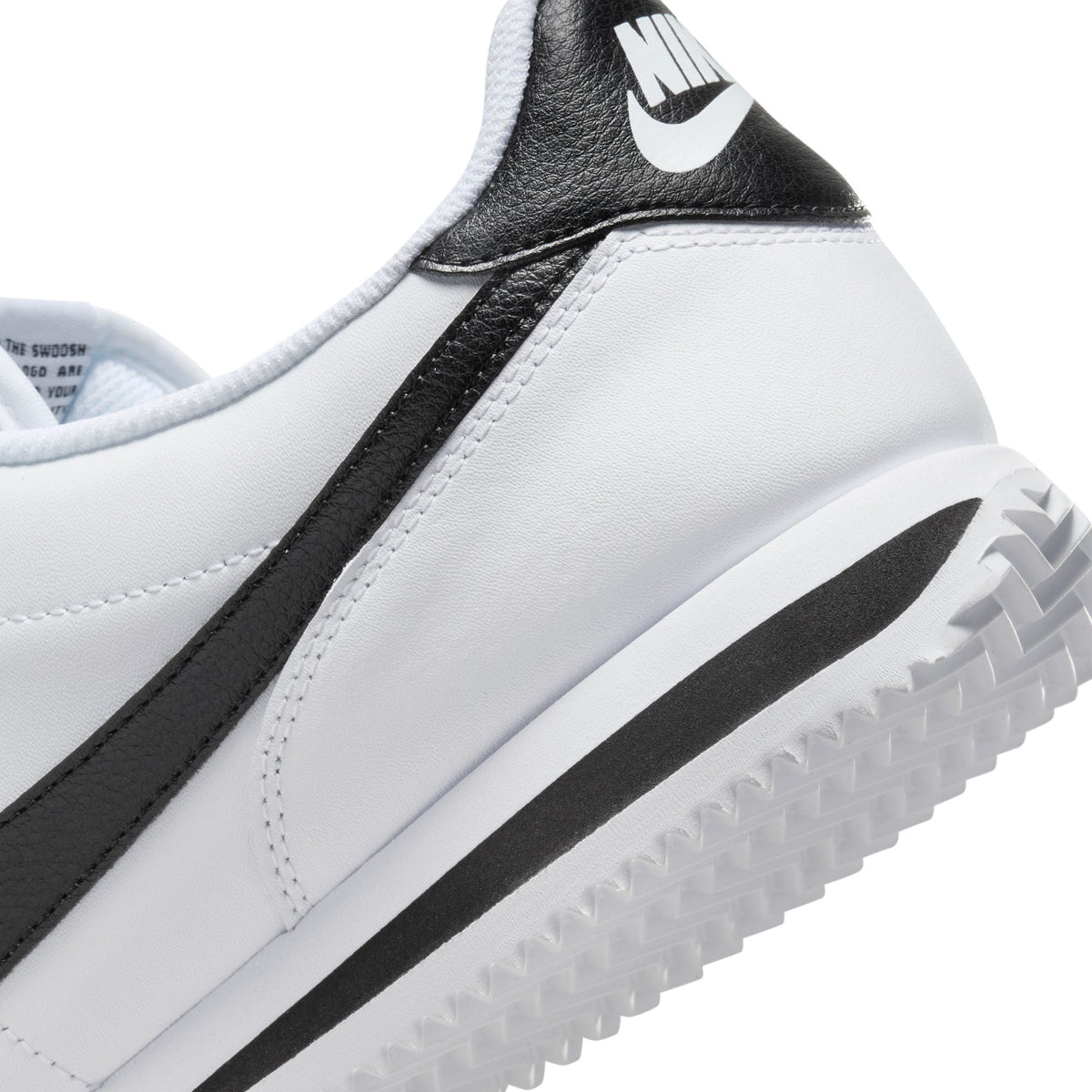 Nike men's Cortez white and black sneakers, side view with classic low-top design