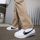 Nike men's Cortez white and black sneakers with classic low-top design and contrasting swoosh logo