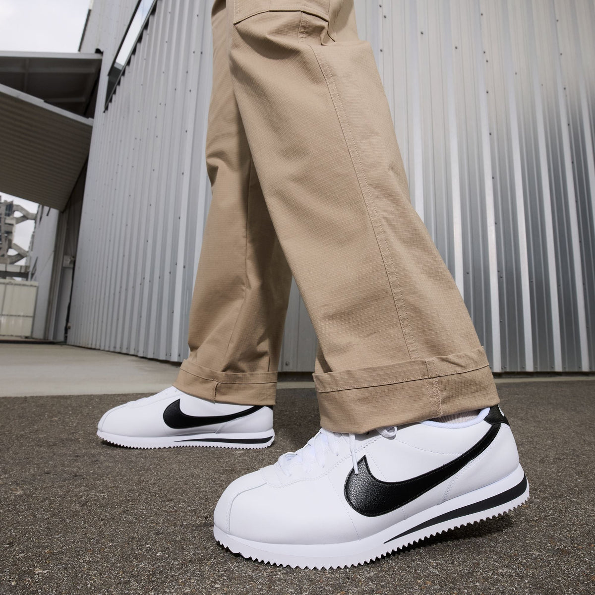 Nike men's Cortez white and black sneakers with classic low-top design and contrasting swoosh logo