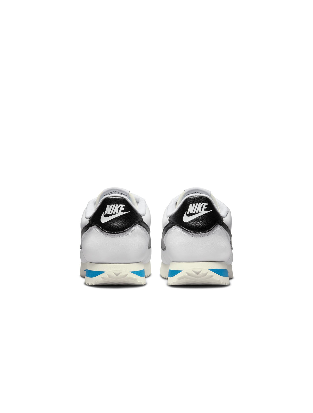 White and black Nike women's Cortez leather sneakers, showcasing classic design and sporty style.