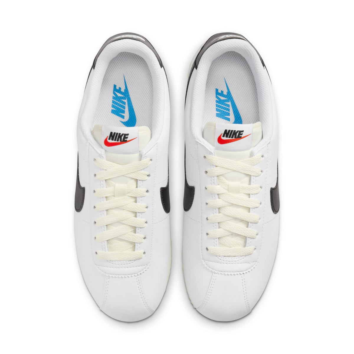 White and black Nike women's Cortez leather sneakers, showcasing classic design and stylish footwear for women.