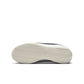White and black Nike Women's Cortez leather sneakers featuring classic design and white laces, perfect for casual wear.