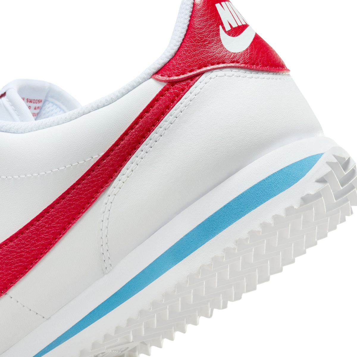 Nike Womens Cortez Leather Forrest Gump sneakers in white with red accents, showcasing classic Nike athletic footwear style.
