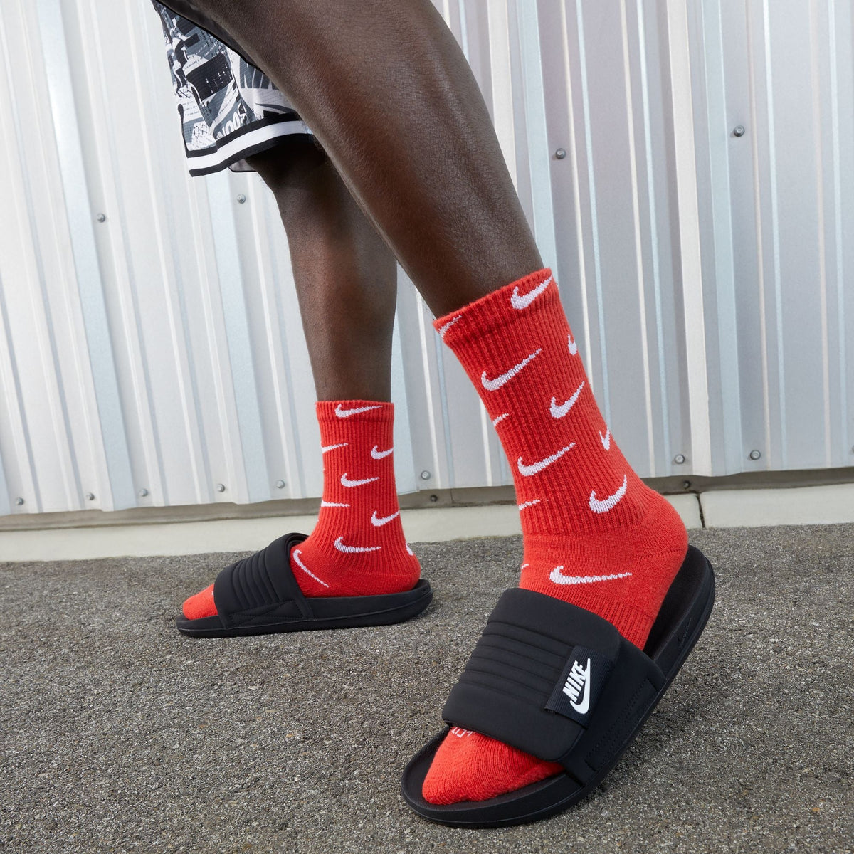 Nike men's Offcourt Adjust slides in black, showing cushioned slip-on sandals with adjustable straps